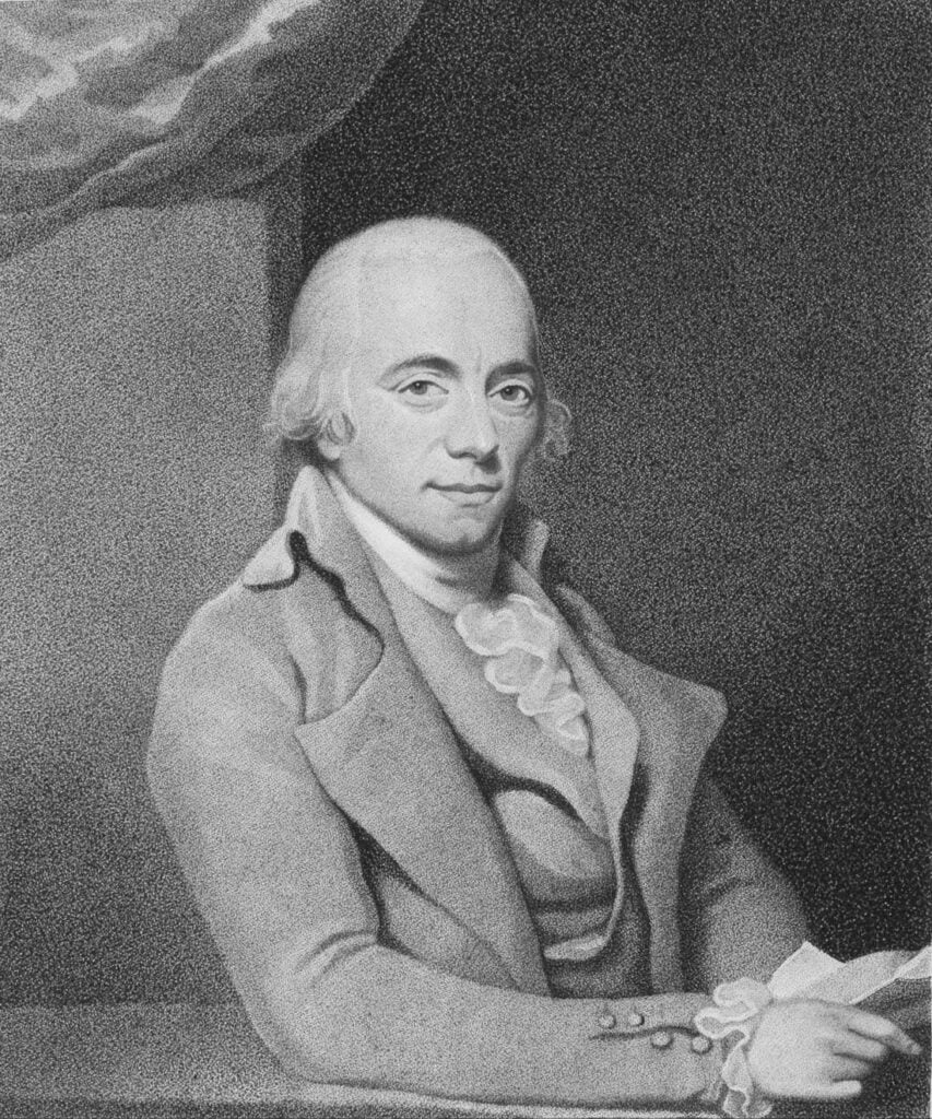 Black and white drawing of classical era man in suit smiling on a desk.